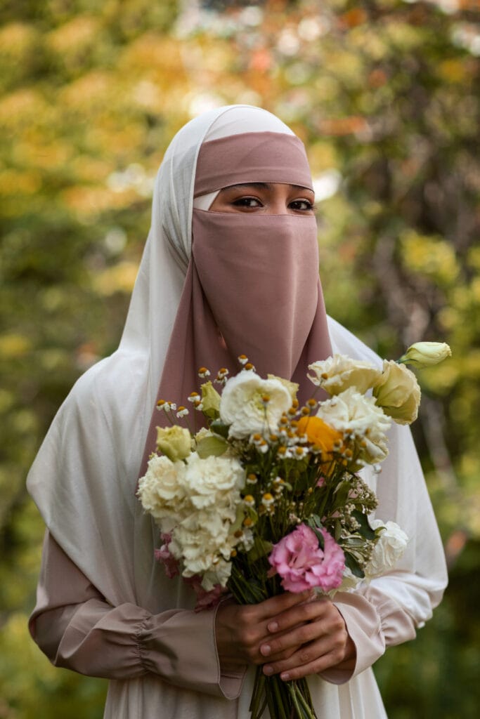 medium shot muslim woman posing with flowers edited medium shot muslim woman posing with flowers edited